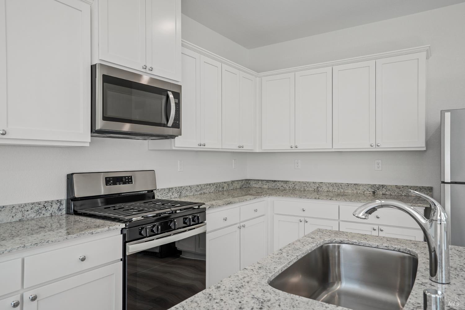 2241 Front Porch Lane Rio Vista, CA 94571 - Photo 5 of 23 a kitchen with a sink stove and microwave