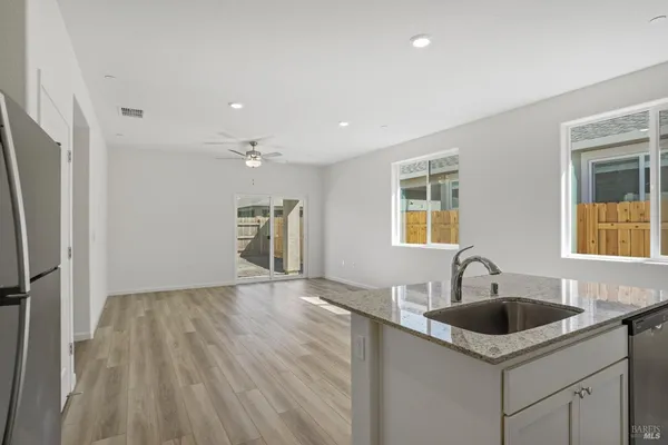 a kitchen with a sink cabinets and wooden floor