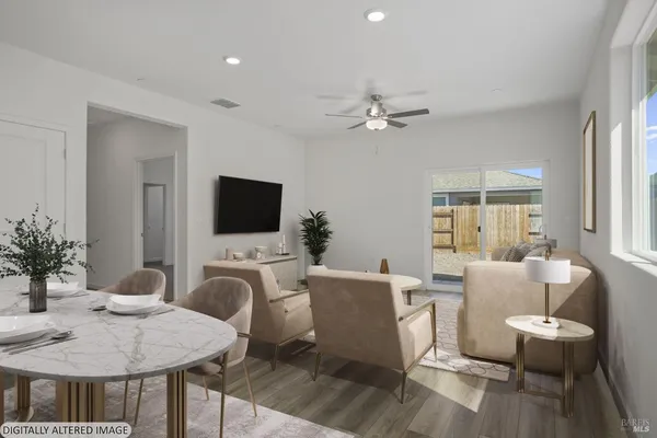 a living room with furniture a flat screen tv and a window