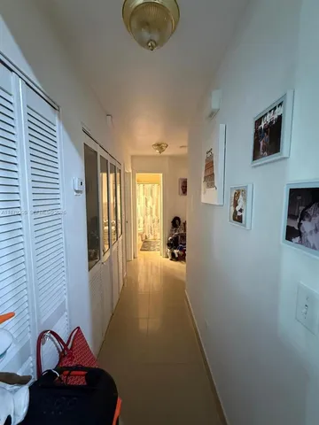 a hallway with a couch and chandelier