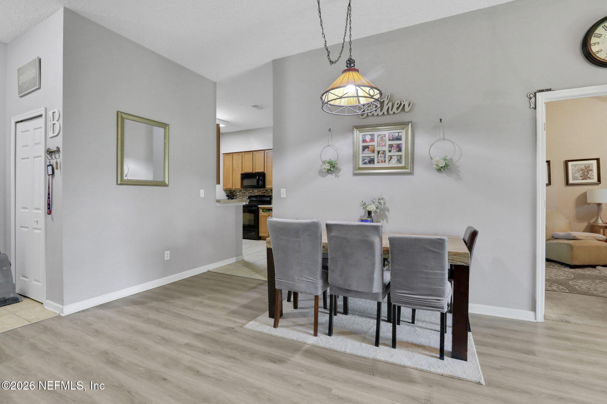 706 Golden Lake Loop St. Augustine, FL 32084 - Photo 12 of 32 a view of a dining room with furniture and wooden floor