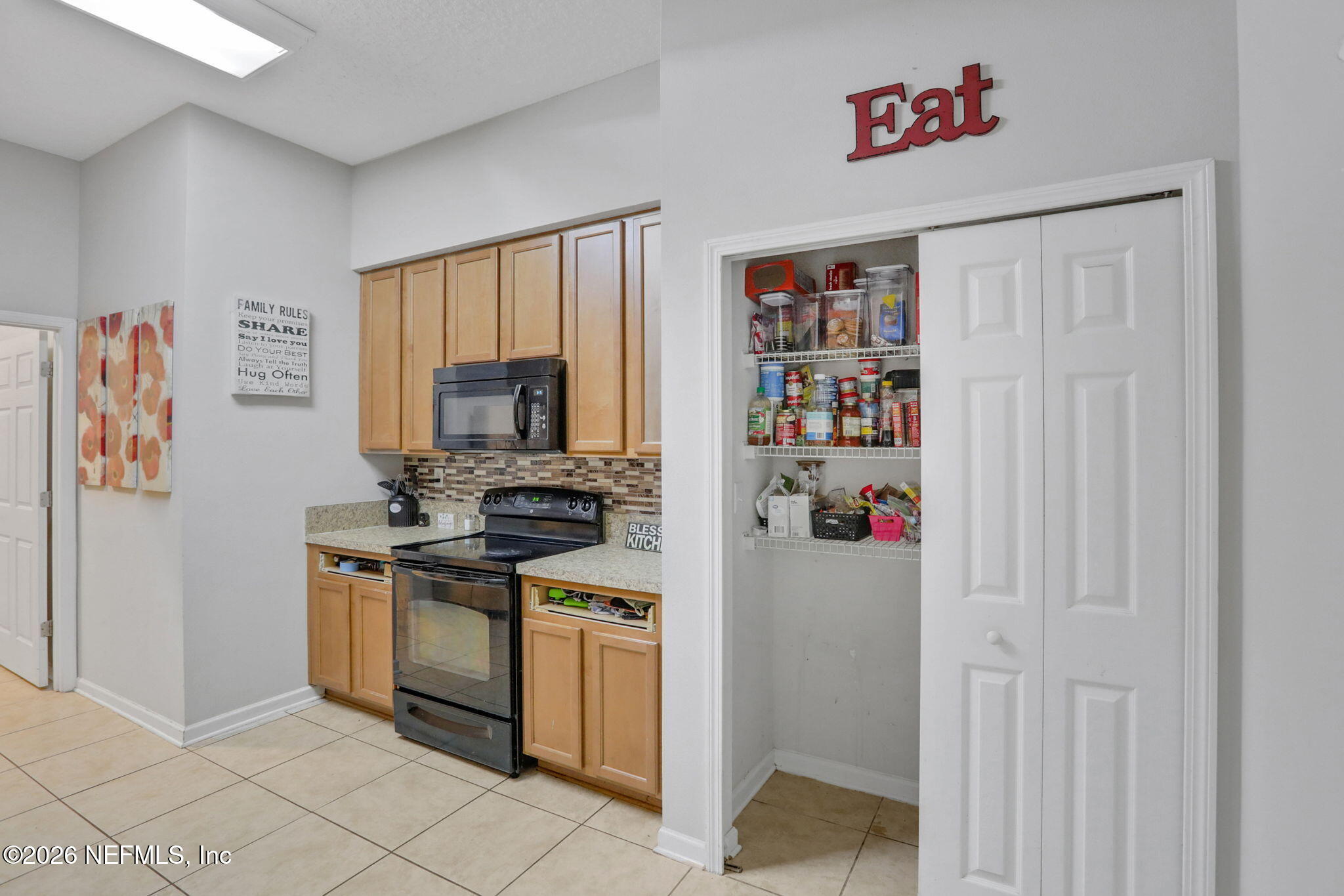 706 Golden Lake Loop St. Augustine, FL 32084 - Photo 13 of 32 a kitchen with stainless steel appliances granite countertop a refrigerator and a stove