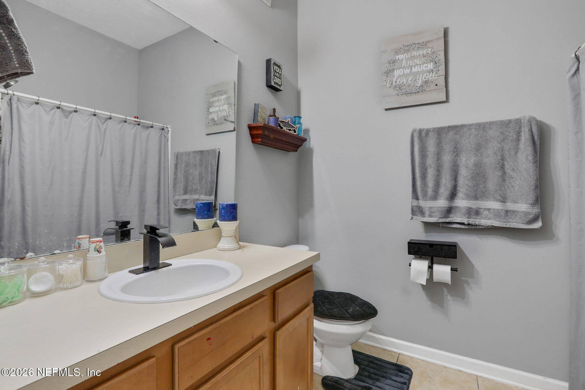 706 Golden Lake Loop St. Augustine, FL 32084 - Photo 23 of 32 a bathroom with a granite countertop sink and a toilet
