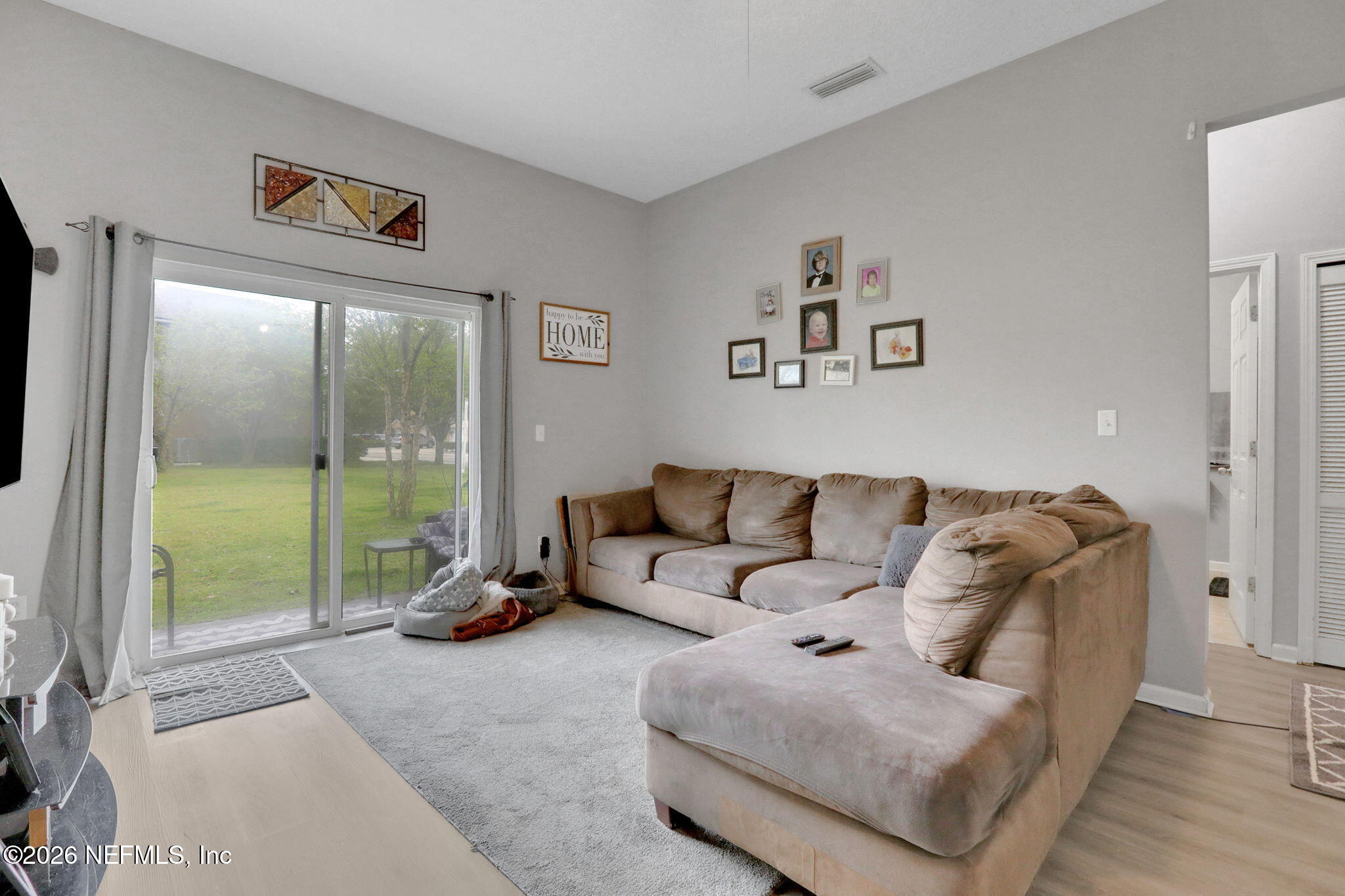 706 Golden Lake Loop St. Augustine, FL 32084 - Photo 9 of 32 a living room with furniture and a floor to ceiling window