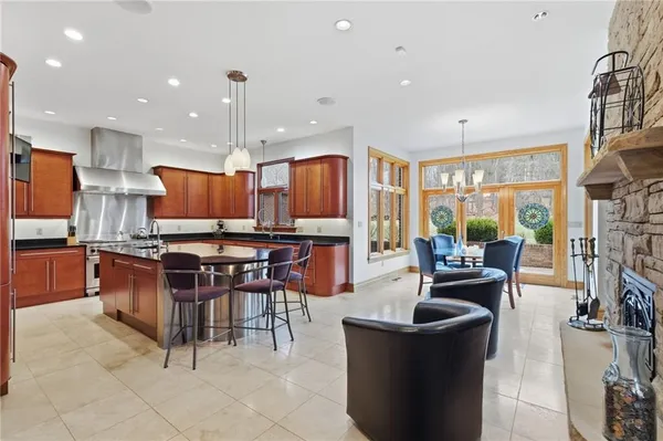 a kitchen with stainless steel appliances kitchen island granite countertop a stove and cabinets