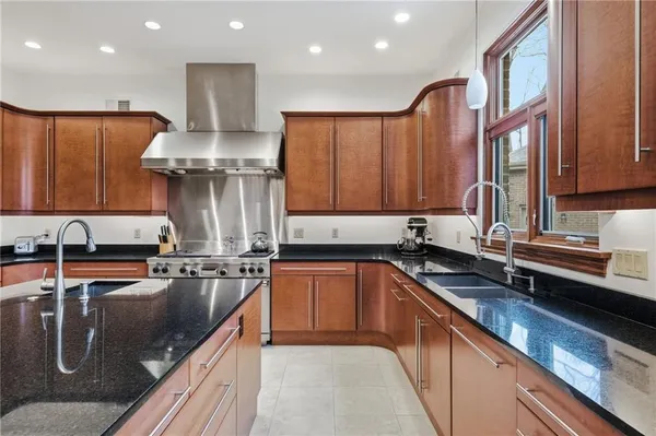 a kitchen with stainless steel appliances a sink stove and cabinets
