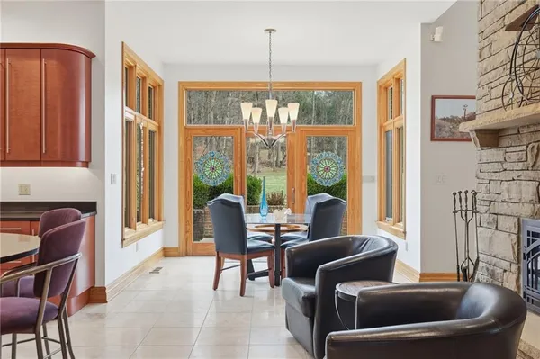 a dining room with furniture a chandelier and wooden floor