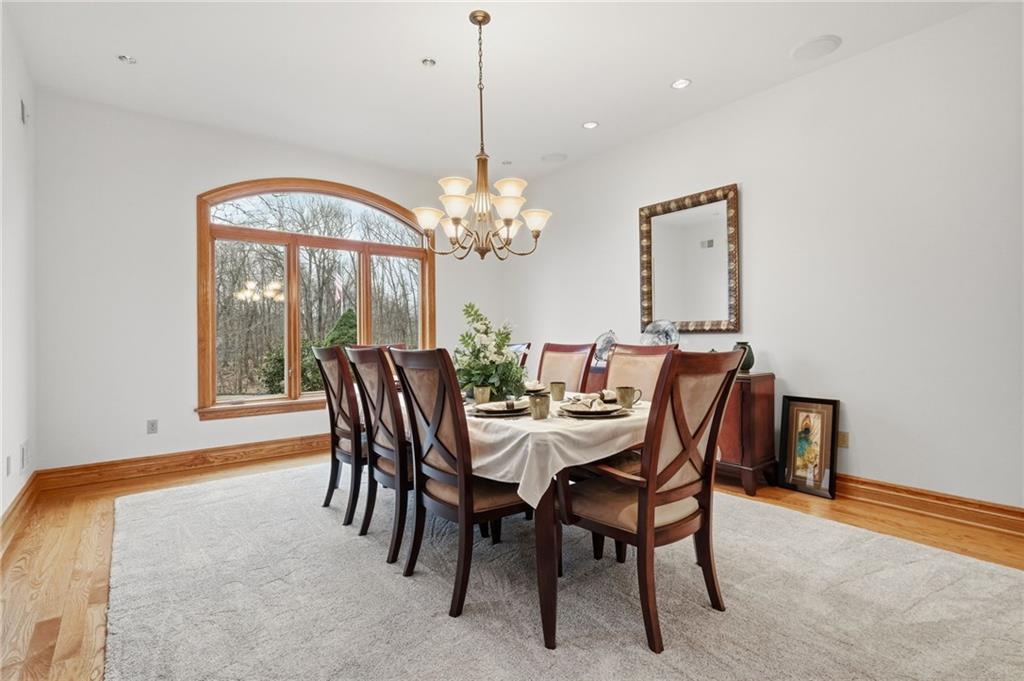 1653 Chapel Ridge Mars, PA 16046 - Photo 42 of 50 a dining room with furniture a chandelier and a rug