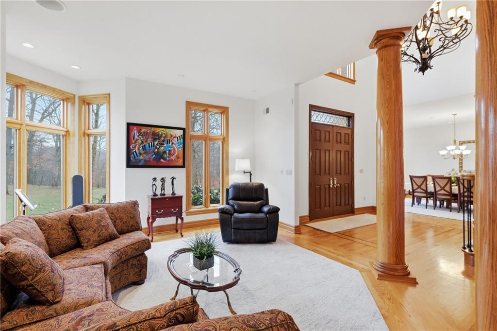 1653 Chapel Ridge Mars, PA 16046 - Photo 43 of 50 a living room with furniture a lamp and a chandelier