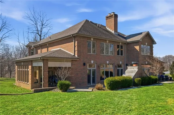a front view of a house with yard and green space