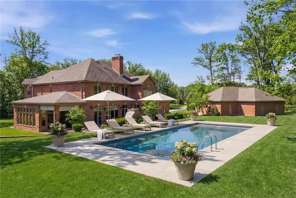 a view of a house with swimming pool and sitting area