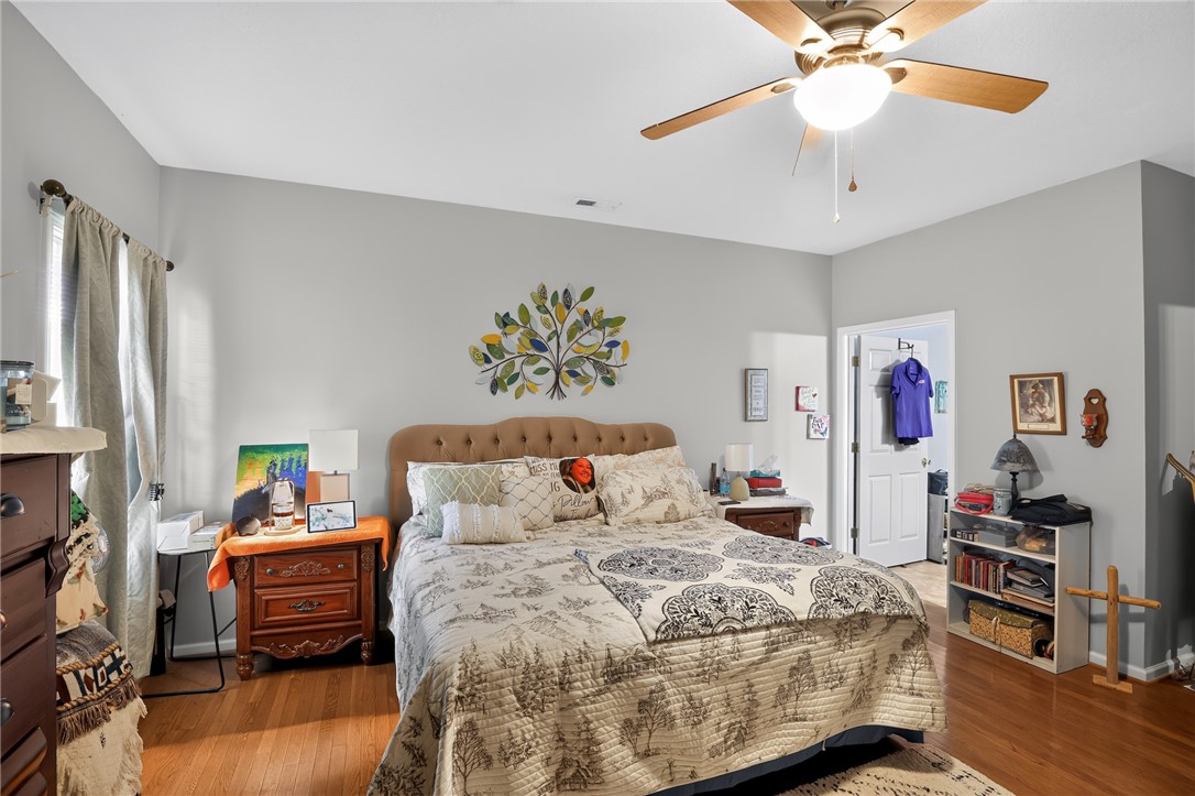 144 Elliott Circle Anderson, SC 29621 - Photo 13 of 30 An inviting bedroom features a warm wood floor and a ceiling fan for comfort.