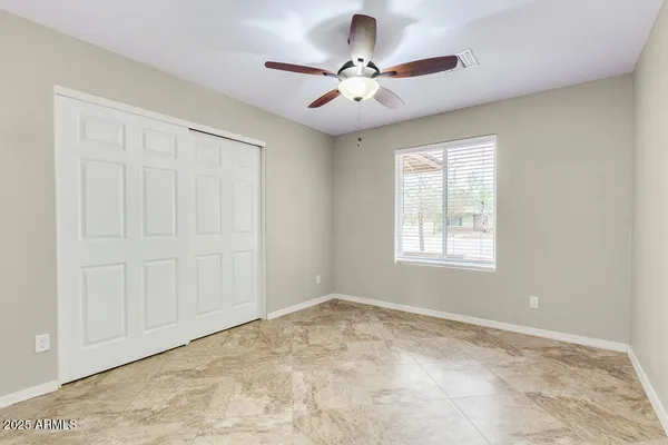 a view of a livingroom with a ceiling fan and window