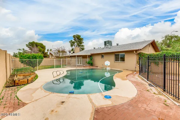 swimming pool view with a garden space