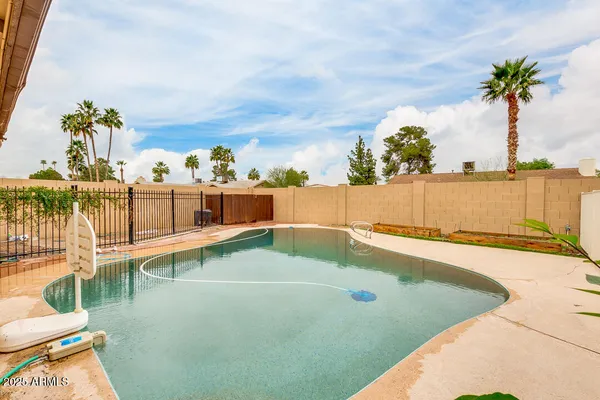 a view of a swimming pool and an outdoor seating