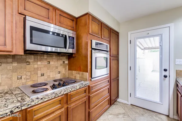 a kitchen with stainless steel appliances granite countertop a stove a microwave and a sink