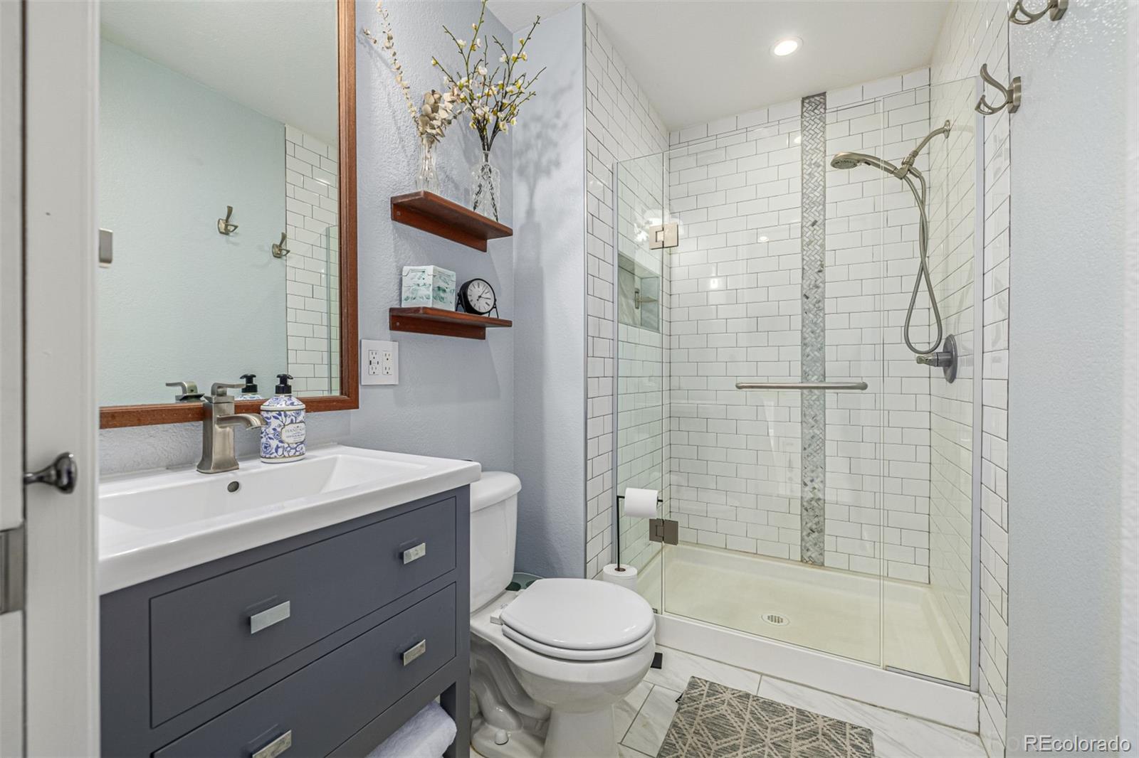 965 Wolff Street, Unit D Denver, CO 80204 - Photo 11 of 29 a bathroom with a sink toilet and shower