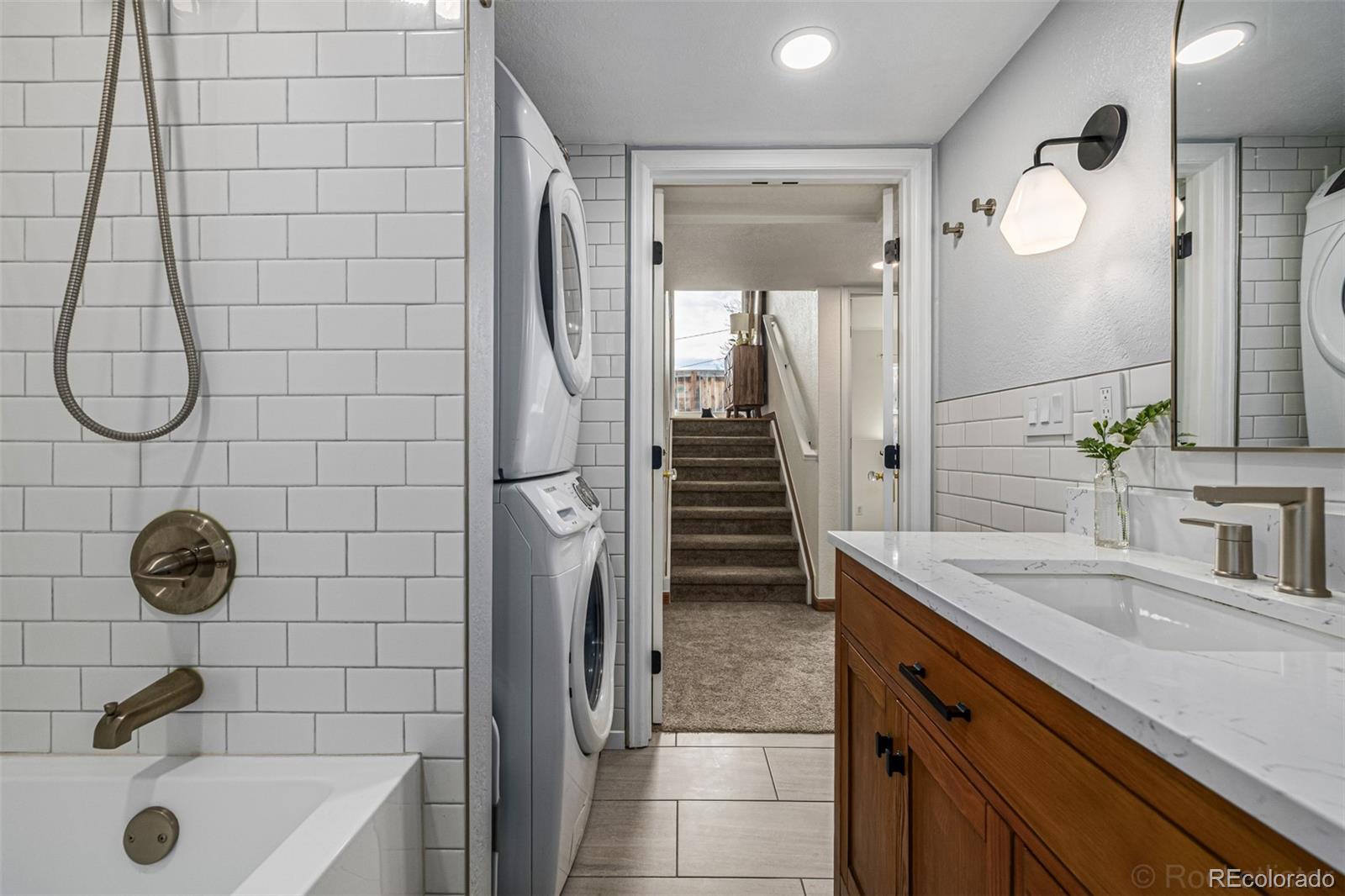 965 Wolff Street, Unit D Denver, CO 80204 - Photo 13 of 29 a bathroom with a sink a shower and a mirror