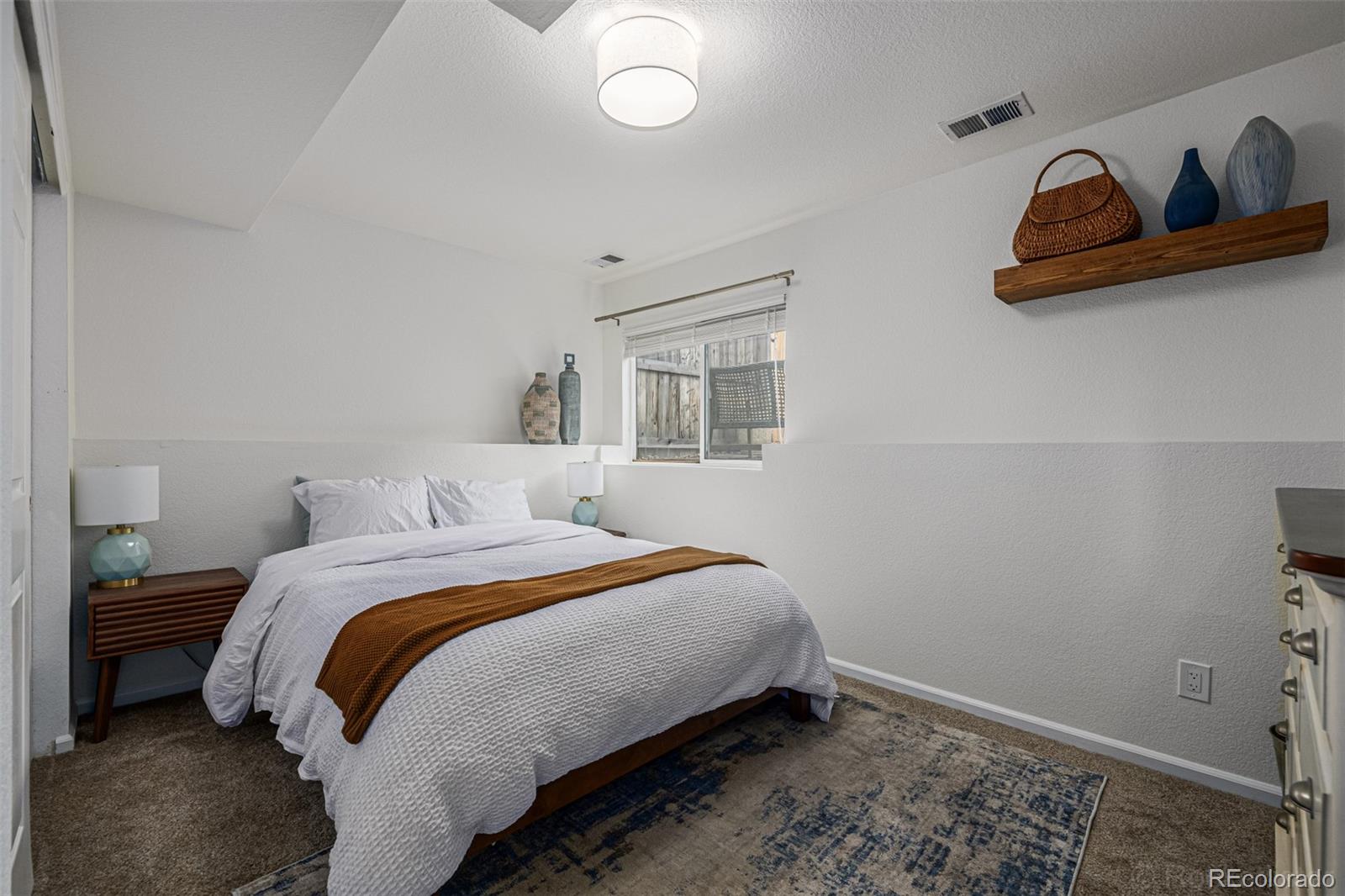 965 Wolff Street, Unit D Denver, CO 80204 - Photo 15 of 29 a bedroom with a bed and cabinets