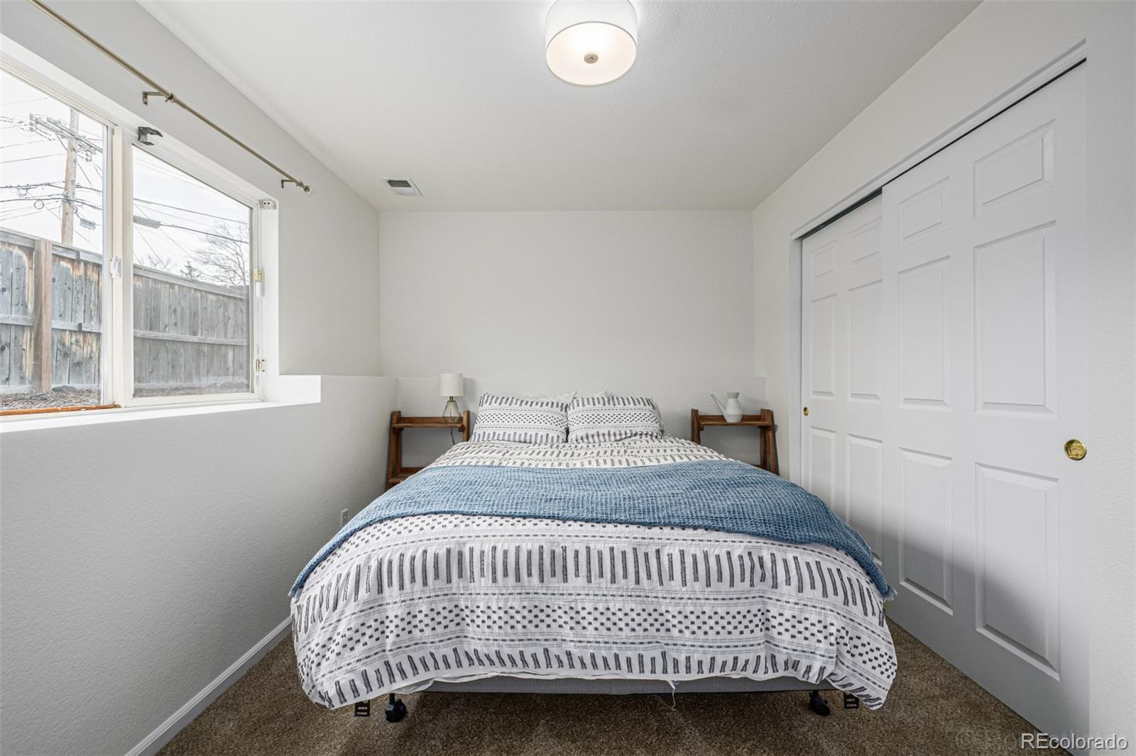 965 Wolff Street, Unit D Denver, CO 80204 - Photo 16 of 29 a bedroom with a bed and a window