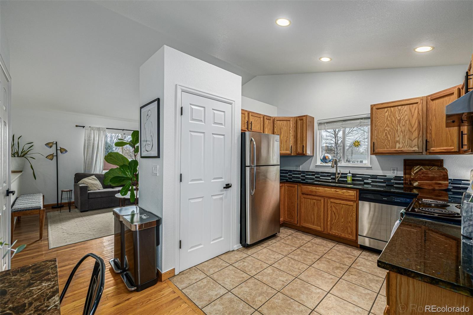 965 Wolff Street, Unit D Denver, CO 80204 - Photo 5 of 29 a kitchen with stainless steel appliances granite countertop a refrigerator and a stove top oven