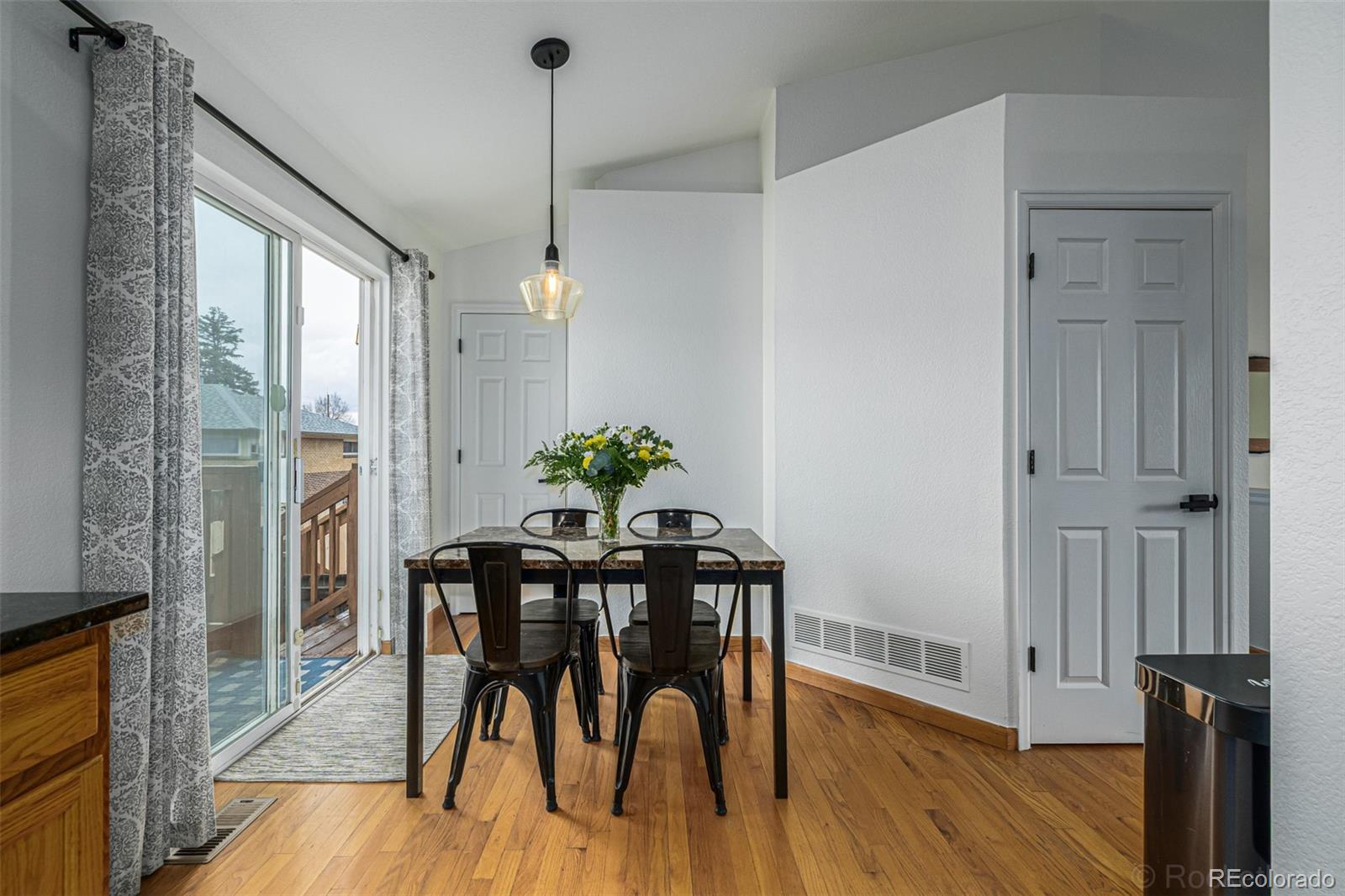 965 Wolff Street, Unit D Denver, CO 80204 - Photo 10 of 29 a view of a dining room with furniture window and wooden floor