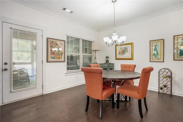 a dining room with furniture a chandelier and window