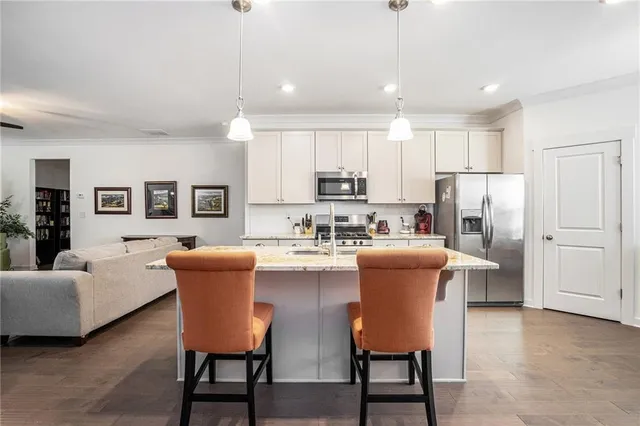 a dining room with furniture and a kitchen view