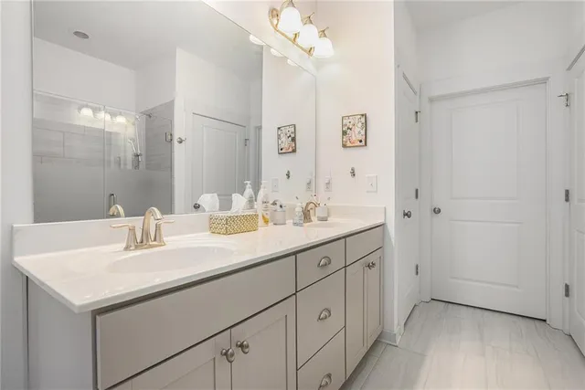 a bathroom with a sink double vanity and a mirror