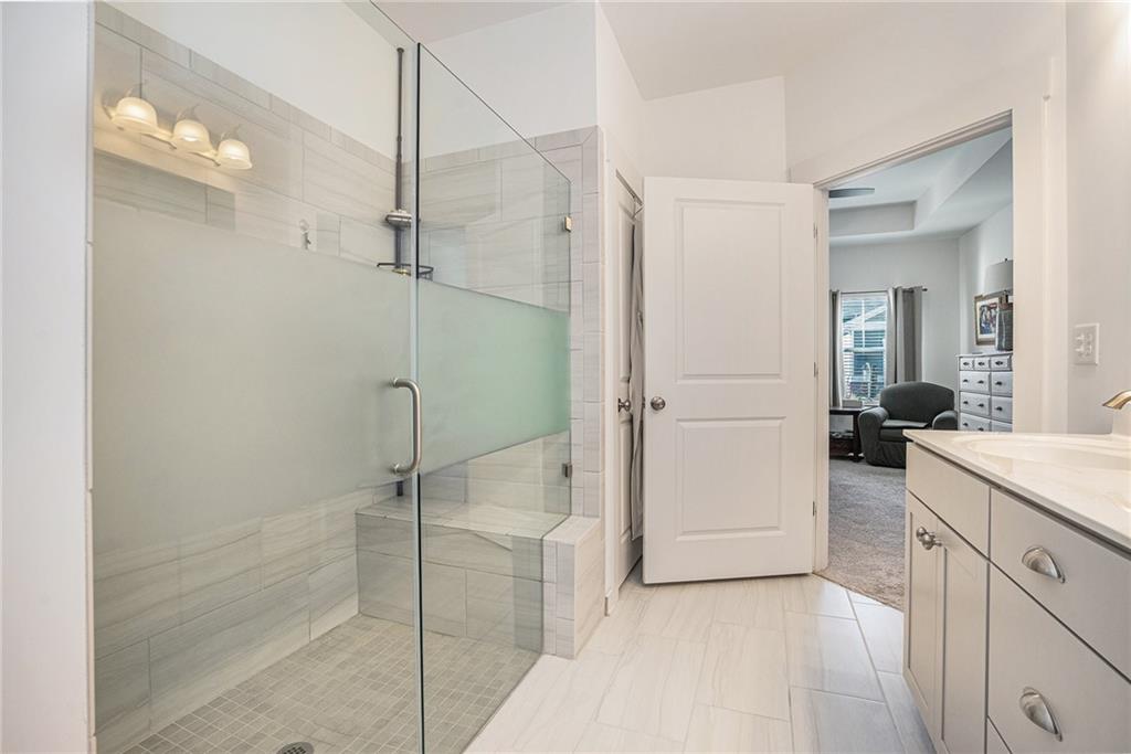 2473 Rathburn Circle Loganville, GA 30052 - Photo 23 of 32 a bathroom with a shower and a sink