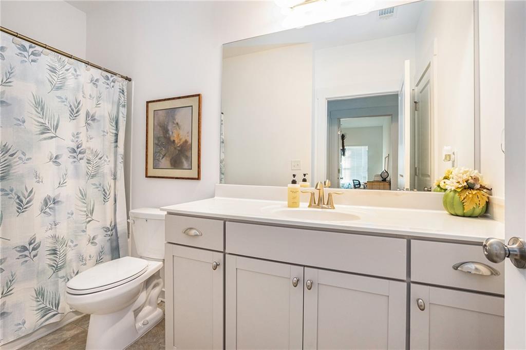 2473 Rathburn Circle Loganville, GA 30052 - Photo 25 of 32 a bathroom with a sink a toilet and shower