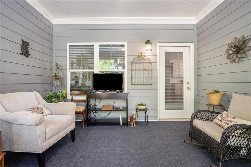 2473 Rathburn Circle Loganville, GA 30052 - Photo 26 of 32 a living room with furniture and a flat screen tv