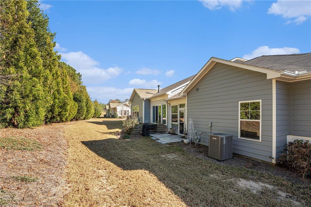 2473 Rathburn Circle Loganville, GA 30052 - Photo 30 of 32 a view of a house with backyard and sitting area