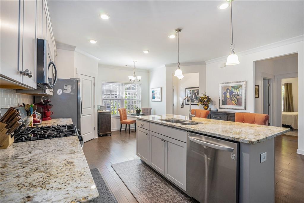 2473 Rathburn Circle Loganville, GA 30052 - Photo 4 of 32 a kitchen with sink stove and refrigerator