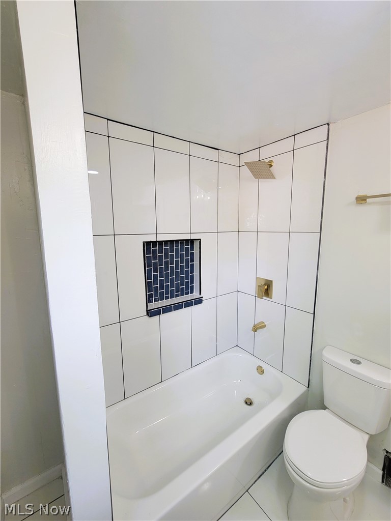 1557 Maplegrove Road South Euclid, OH 44121 - Photo 18 of 23 Bathroom featuring tiled shower / bath combo, tile floors, and toilet