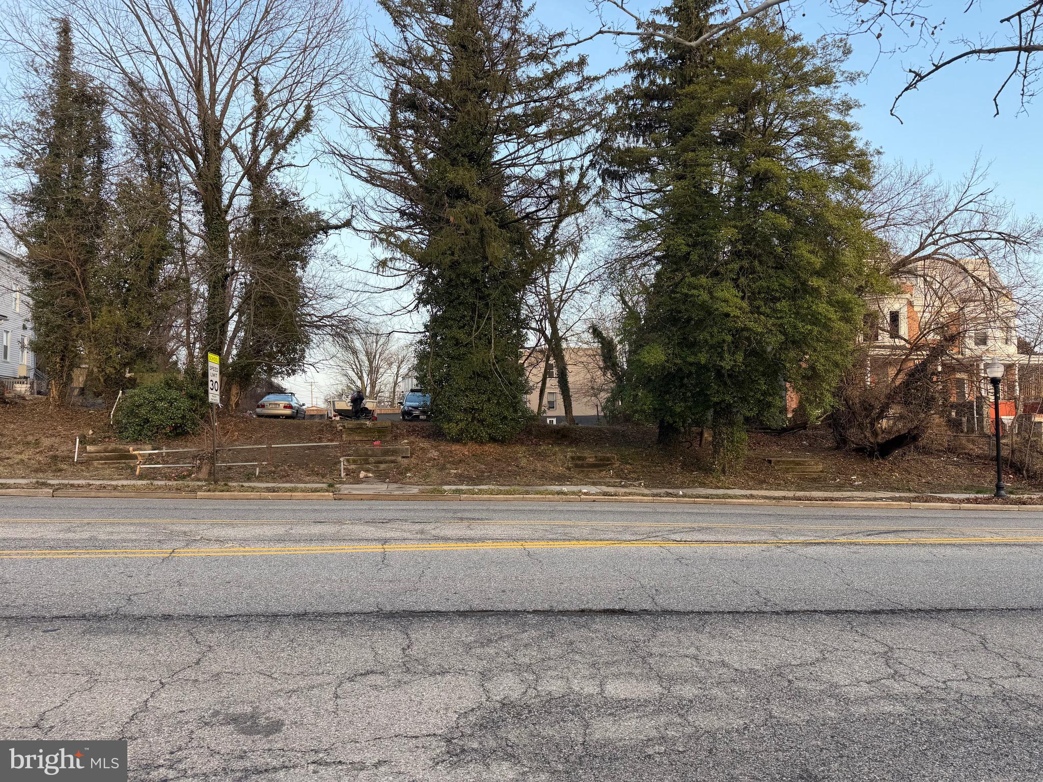 2513 Garrison Boulevard Baltimore, MD 21216 - Photo 2 of 2 a view of a yard with large trees
