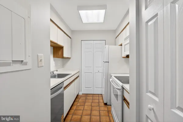 a kitchen with a sink and a stove top oven