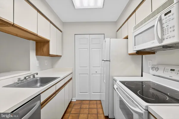 a kitchen with a sink cabinets and utility