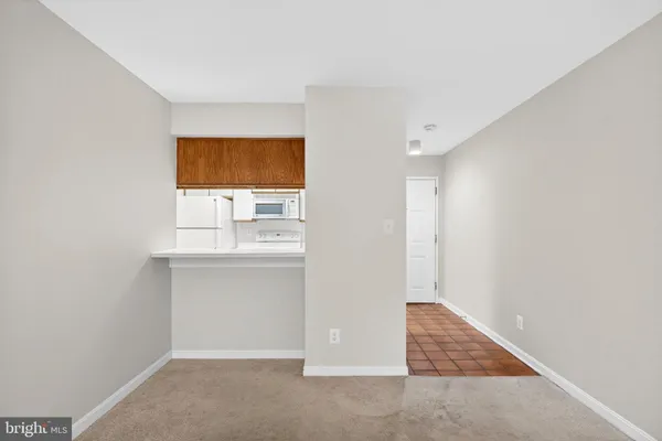 an empty room with a bench and window