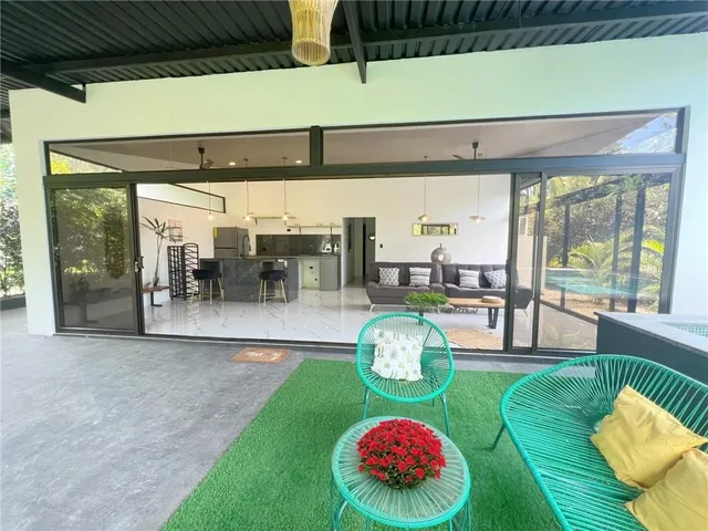 a view of a porch with chairs and couches with wooden floor