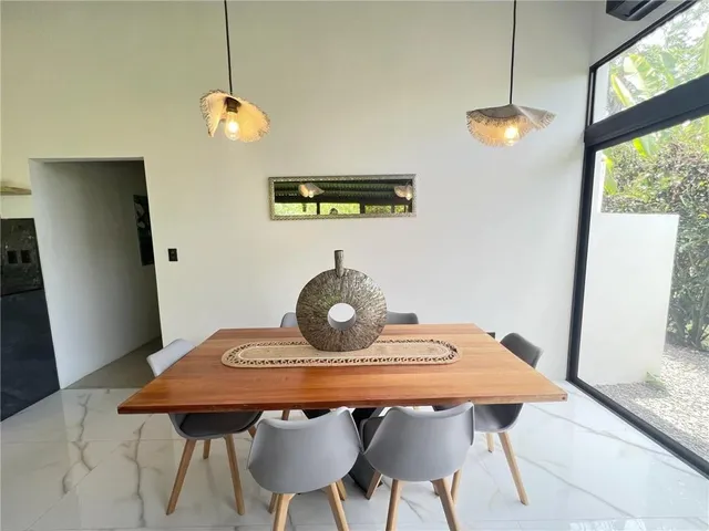 a view of a dining room with furniture and window