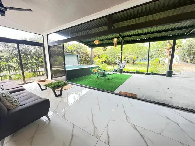 a view of a patio with a table chairs and a backyard