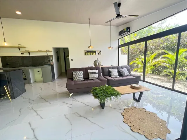 a living room with furniture and large windows