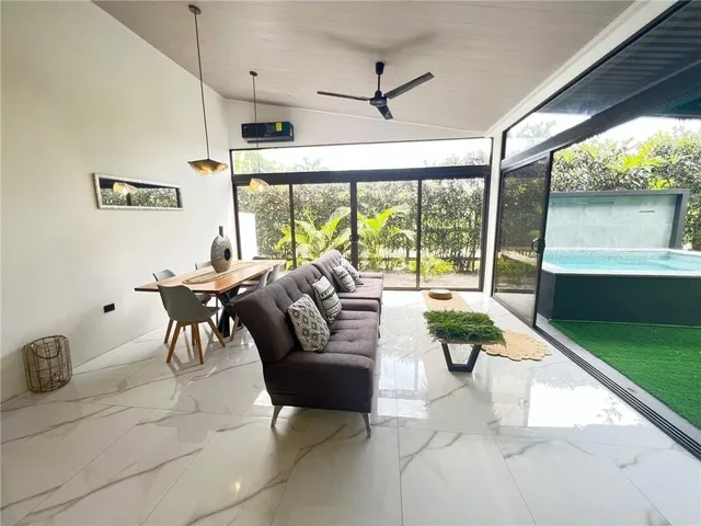 a living room with lots of furniture and a chandelier