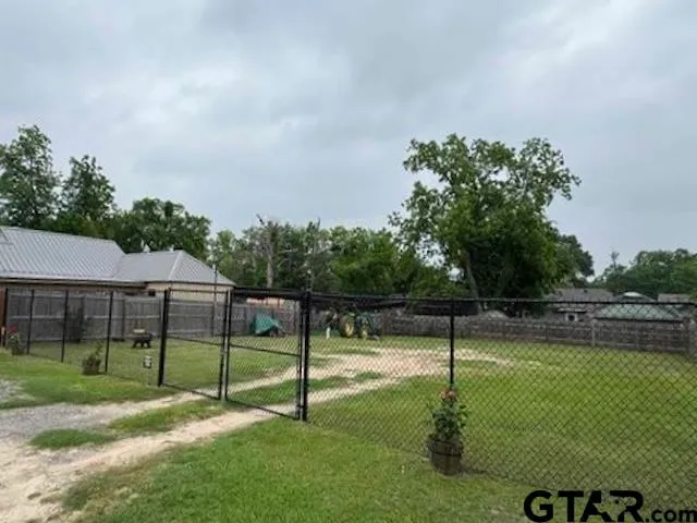 a swimming pool with lots of tress in the background