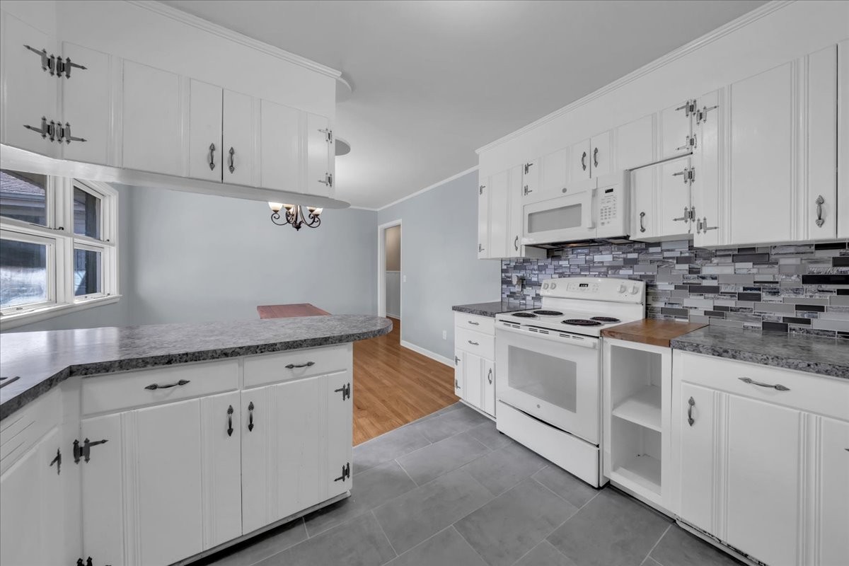902 Sycamore Drive Manchester, TN 37355 - Photo 18 of 51 a kitchen with granite countertop white cabinets and white stainless steel appliances