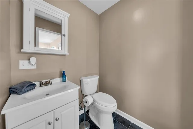 a white toilet sitting next to a bathroom sink
