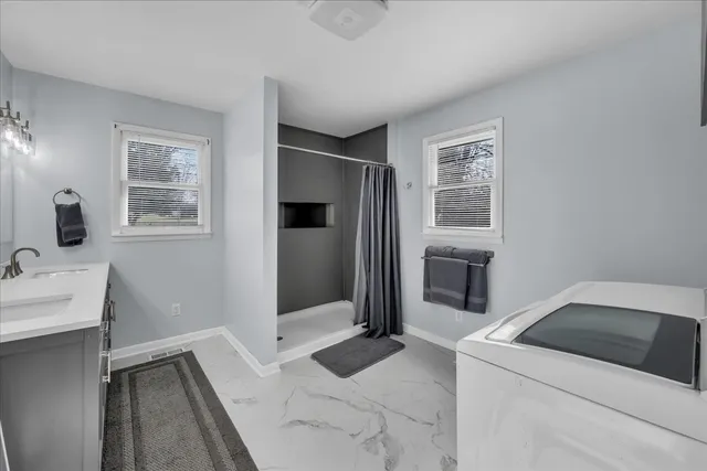 a bedroom with a bed and a refrigerator