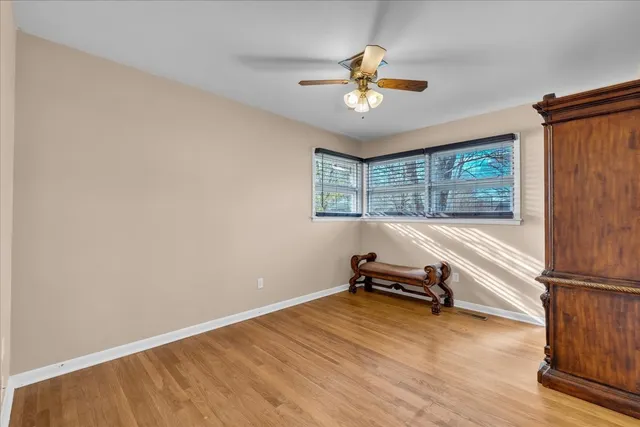 a room with a window and a ceiling fan