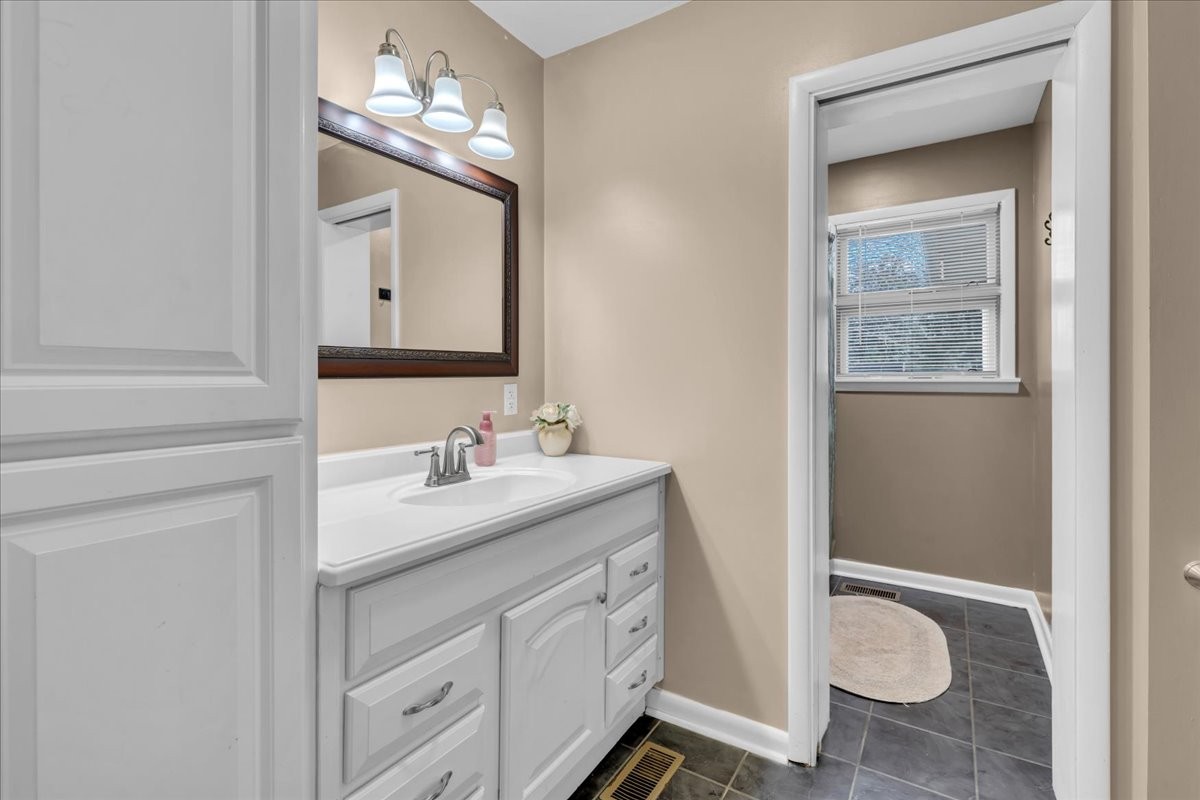 902 Sycamore Drive Manchester, TN 37355 - Photo 38 of 56 a bathroom with a granite countertop sink and a mirror